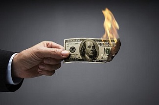 Businessman burning 100 dollar bill